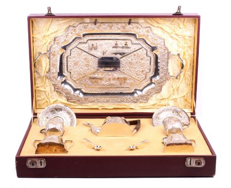 A Swami style Anglo-Indian silver tea set. Comprising a large quatrefoil tray, teapot, lidded jug, sugar bowl and a pair of c