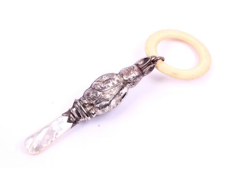 A vintage silver Peter Rabbit teether. The silver rabbit rattle (indistinct hallmarks) on a mother of pearl handle with a rou