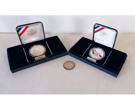 A USA silver dollar "Smithsonian Institution 150th Anniversary" 1996 and the 2003 First Flight silver dollar, both proof 'P',