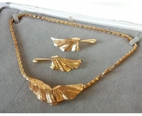 A 9ct yellow gold necklace and earrings, designed as a snake link chain suspending a scroll detail with bead drop, and a matc