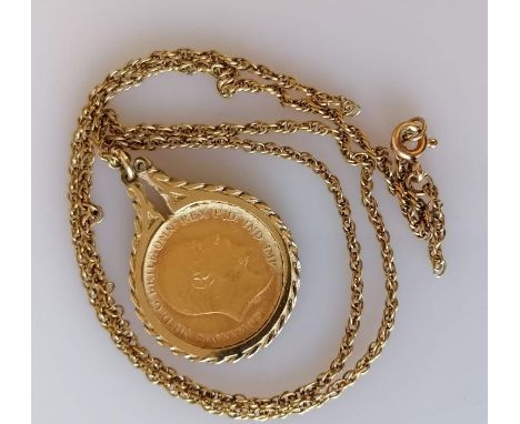 An Edwardian gold half sovereign, 1910, on a 9ct gold mount and chain, hallmarked, chain damaged, 9.5g