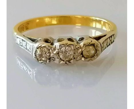 A gold three-stone diamond illusion-set ring, size M, stamped 18ct, 3.2g