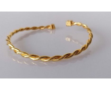 A Middle-East gold rope-twist bangle, stamped and tests for 22ct, 25g