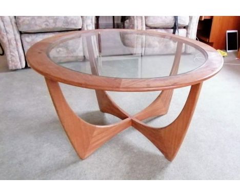 A G-Plan "Astro" teak circular coffee table, labeled, with plate glass insert, 84cm diameter, 45cm H. Note: this item will be