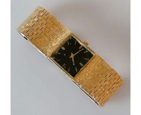 A vintage Marvin black face square dial manual watch with baton markers, 23mm, with a textured gold bark effect adjustable br