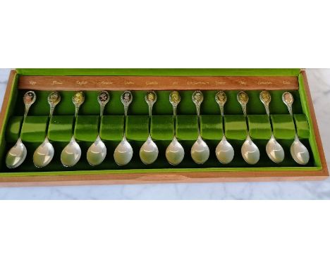 A cased limited edition boxed set of twelve silver flower spoons commissioned by The Royal Horticultural Society, each inset 