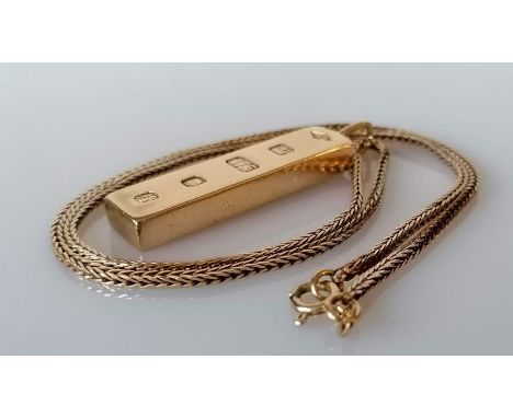 A 9ct yellow gold ingot pendant, hallmarked for London 1976 on a 9ct gold neck chain, 48 cm with import marks, 41.75g