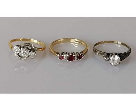 A three-stone diamond ring in an illusion setting on an 18ct gold and sapphire setting, size M, 3g; a three-stone garnet and 