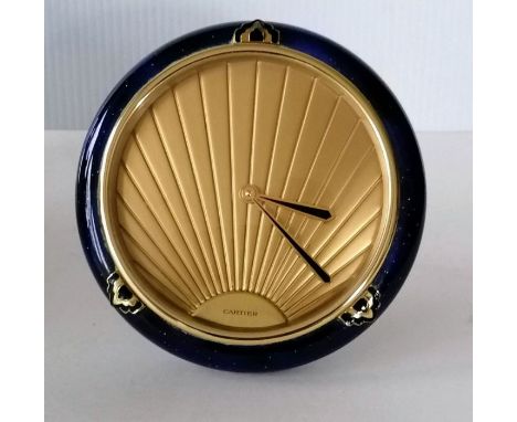 A Cartier Art Deco-style table clock with stylized face, signed, blue enamel surround on easel support, in working order, 13 