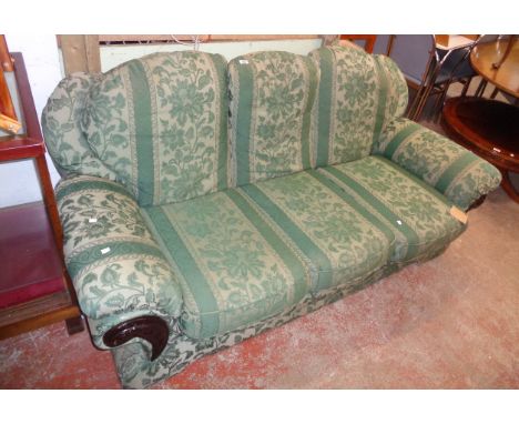 A 6' 3" three seater settee upholstered in green floral tapestry