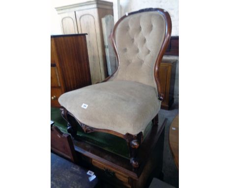 A Victorian walnut part show frame spoon back nursing chair with button velour upholstery, set on ornate cabriole front legs 