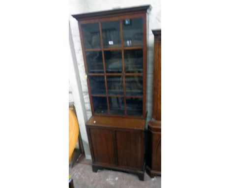 A 27" 19th Century mahogany two part book cabinet with Greek key cornice and adjustable shelves enclosed by a glazed panel do