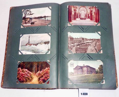 An early 20th Century leather bound album containing a collection of postcards including numerous topographic seaside and arc