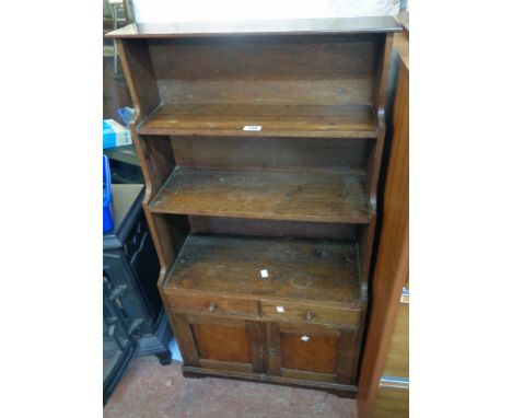 A 23 3/4" late 19th Century mahogany miniature dresser style unit with three shelf open waterfall bookcase over two short dra