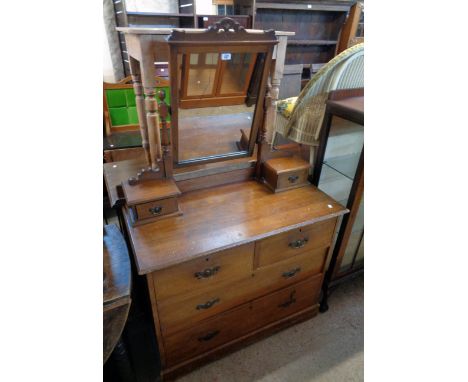 A 3' 3" late Victorian stained walnut dressing chest with oblong swing mirror and flanking trinket drawers over two short and