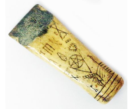 An antique carved bone chisel emblazoned with Masonic symbols including coffin, pentagram, ladder to Heaven, Lamb of God, and