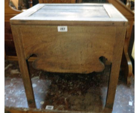 An 18 1/2" 19th Century mahogany box commode with china liner and shaped apron, set on chamfered square legs - liner cracked,