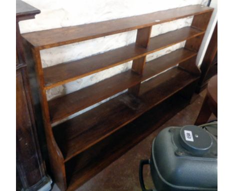 A 6' 20th Century polished oak four shelf open waterfall bookcase with shaped sides - minor wear