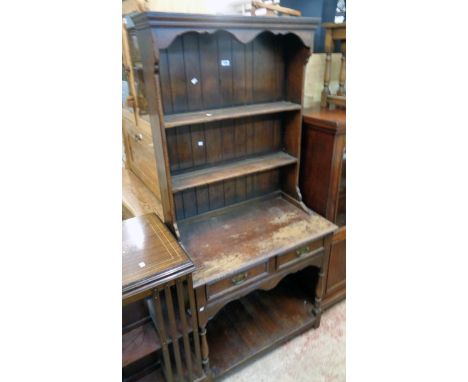A 33" 20th Century Archer &amp; Smith stained oak potboard dresser with two shelf open plate rack over a base with two frieze