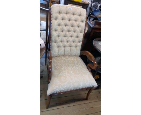 A reproduction mahogany part show frame drawing room armchair in the antique style with button back upholstery and swan patte
