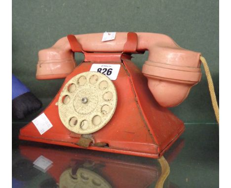 A vintage tin plate and plastic toy telephone