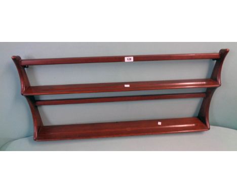 A 3' 2" Ercol dark elm wall mounted two shelf plate rack with shaped sides and original label