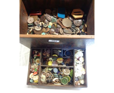 A wooden sewing box containing assorted vintage and other buttons