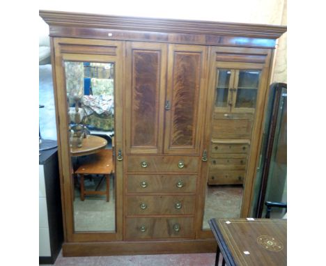 A 6' 4" Edwardian mahogany and strung wardrobe with moulded cornice, central two door cupboard and four graduated drawers und