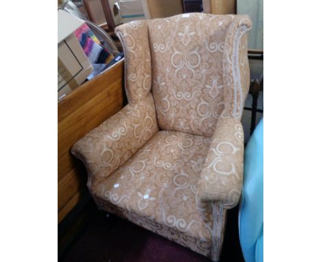 A late Victorian Georgian style wing back armchair upholstered in floral scroll tapestry (some wear), set on cabriole front l