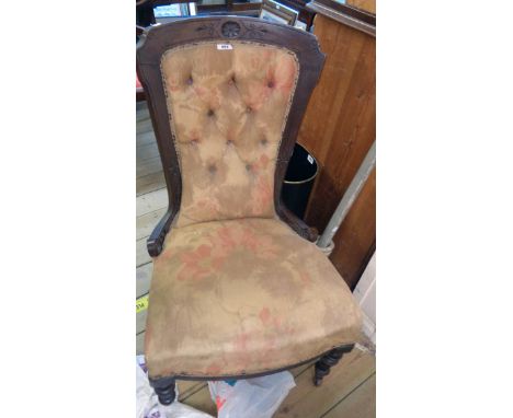 A late Victorian walnut part show frame nursing chair with remains of button back upholstery, set on turned front legs and po
