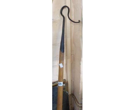 A vintage blacksmith made wrought metal shepherd's crook with wooden handle