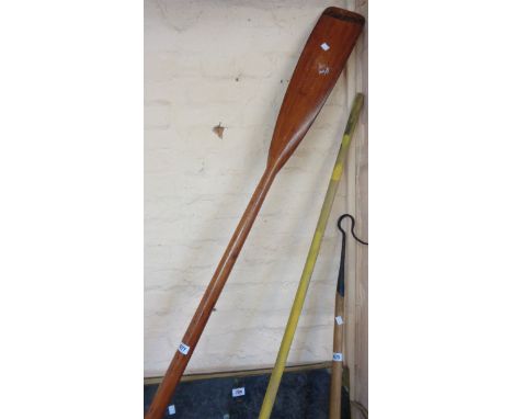 A vintage sweep-oar with wall brackets