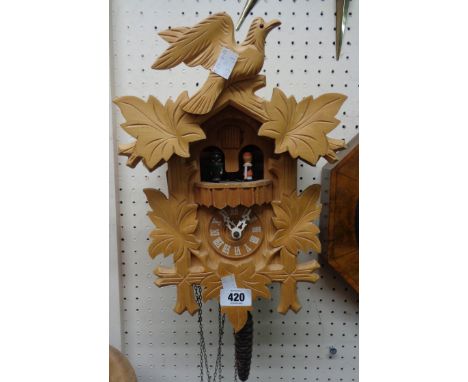 A modern blonde wood cuckoo wall clock with animated figures, musical and triple weight driven movement - a/f