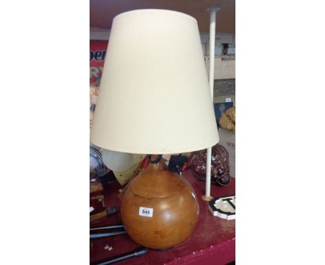 A bulbous turned wood table lamp with wrought iron foot and shade