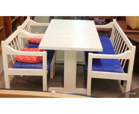 A white painted kitchen table with bench chair and 2 other chairs