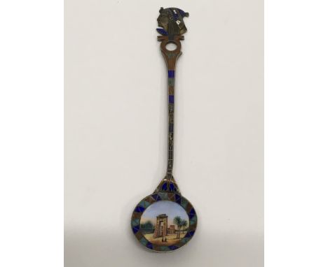 An enamel spoon with an Egyptian view, inscribed 1916.