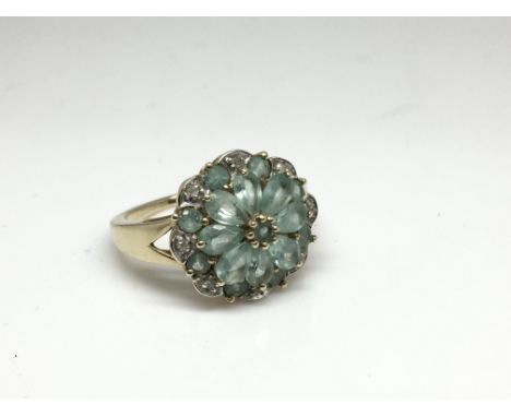 A 9ct gold tourmaline and diamond cluster ring. Size approx O Weight approx 4g