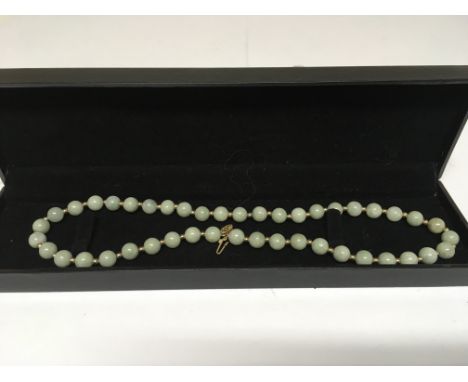 A 15ct gold and Burmese jade type necklace.