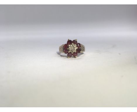 A retro ruby and diamond cluster ring with diamond cut shoulders. Weight approx 3g, size approx M.
