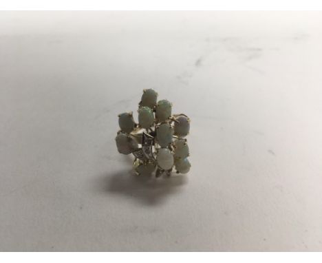 An interesting ladies 9ct yellow gold opal and diamond cocktail cluster ring, size approx M and weight approx 6.5g.