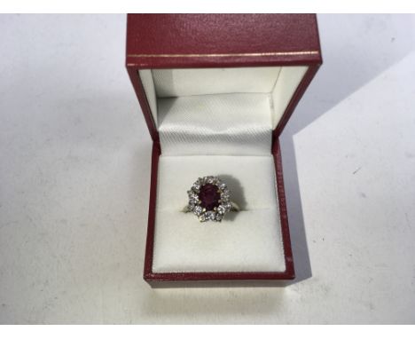 An 18ct gold ruby and diamond cluster ring. Size approx L, weight approx 4.9g