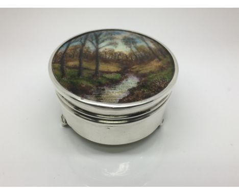 A silver jewellery box with an Arts & Crafts enamel plaque lid in the manner of Charles Fleetwood Varley, approx diameter 6.5