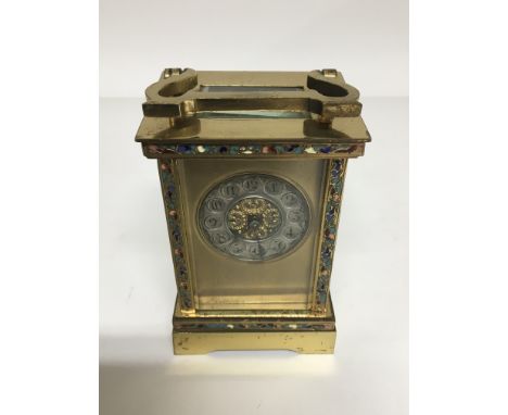 A French brass and enamel carriage clock the silvered dial with Arabic numerals