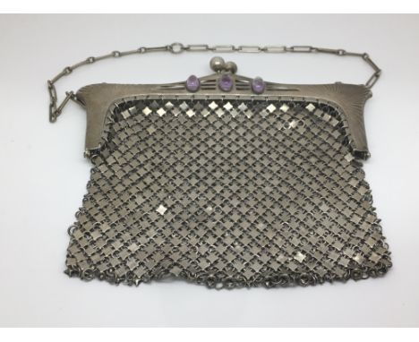 An Art Nouveau German silver purse, marked 800, set with amethyst stones.