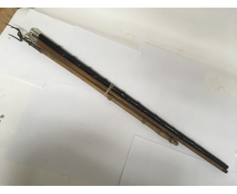 A vintage toasting fork with a long wooden handle by Law and co. and two silver topped walking sticks.