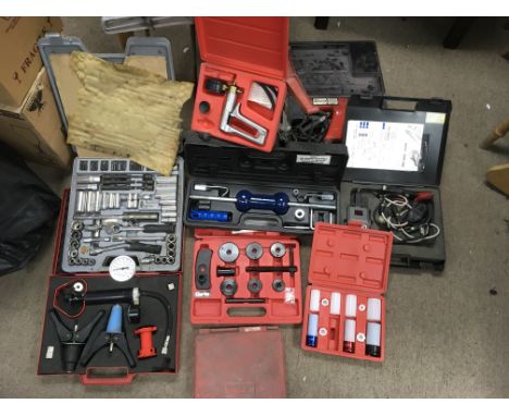 A box containing a collection of car maintainince equipment including Snap-on timing light, Snap-on vacuum kit, teng tools so