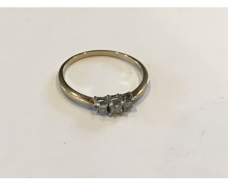 A 9ct yellow gold ring set with three Princess cut diamonds.