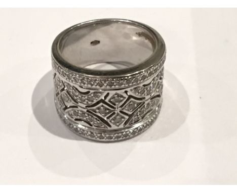 An 18ct white Gold lady’swide band ring with an open pattern set with diamonds. Total diamond carat weight .7 approximately.