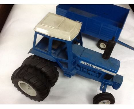 An unboxed "The Big Blue " American ford TW20 tractor with trailer.
