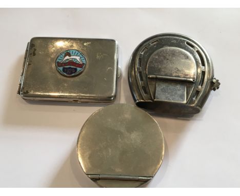 A Victorian silver plated vesta in the form of a horse shoe, A match holder enamel decorated,1925 Wembley and one other plate